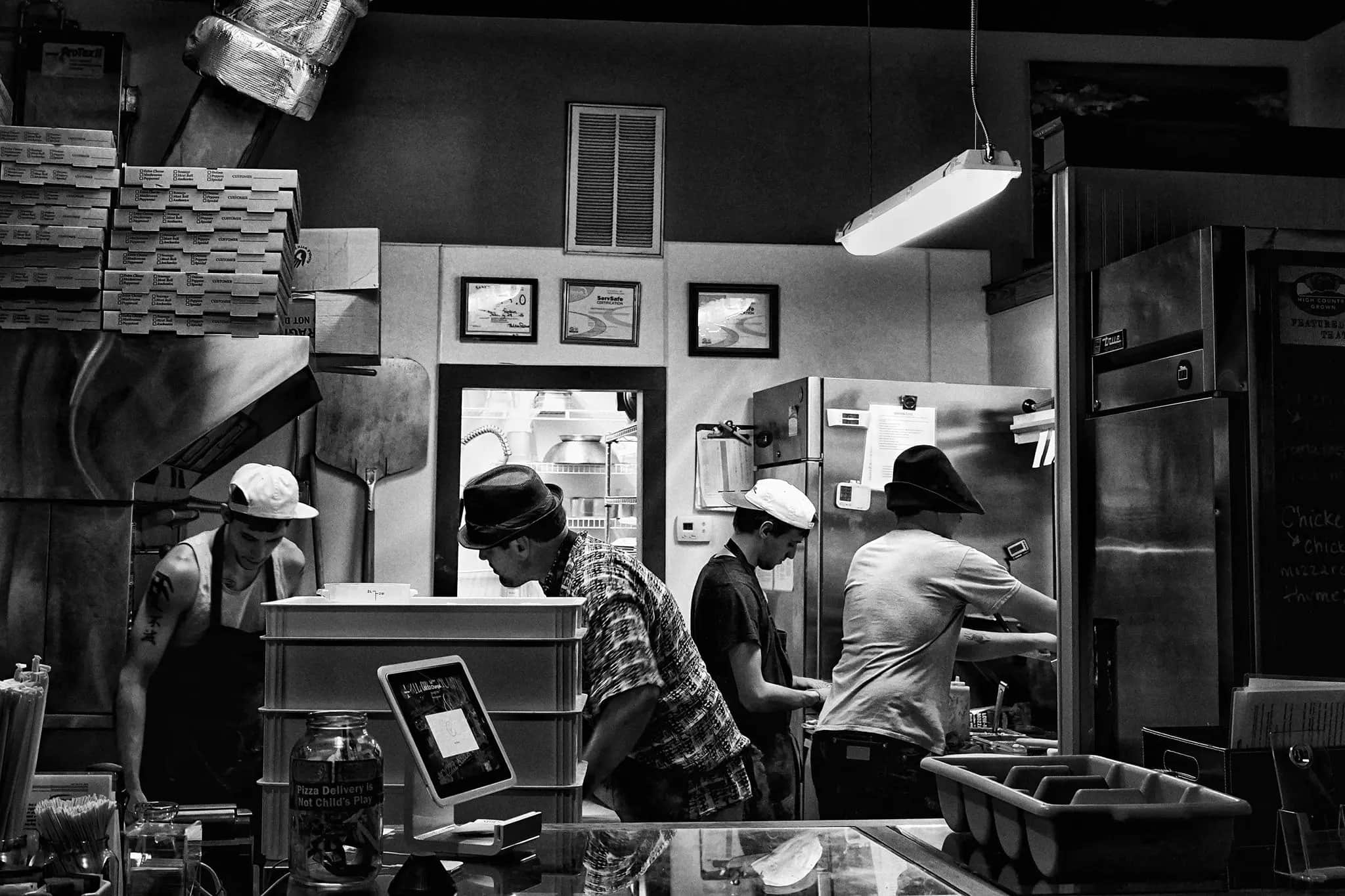 The Pie on the Mountain kitchen crew building pizzas behind the counter